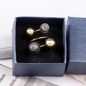 Detail of spiral open gold brass ring featuring black micro-paved crystals in gift box