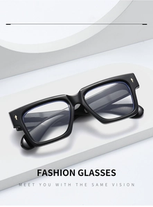 Detail of square black glasses frame with gold arrow rivets and textured temple tips