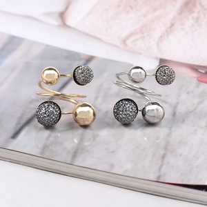 Detail of spiral open rings with smooth gold beads and textured silver accents