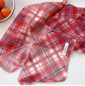 Detail of red checkered elastic mesh scarf with brand label and sheer breathable texture