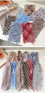 Detailed macro shot of translucent mesh scarves showing diverse floral and plaid patterns