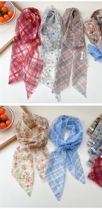 Detailed macro view of vibrant printed mesh twilly scarves with fine hemmed edges