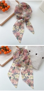 Macro view of floral silk scarf featuring semi-transparent mesh and a neat lockstitch edge