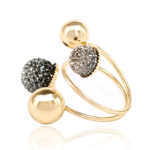 Detail of spiral open gold ring featuring two smooth beads and two dark crystal spheres