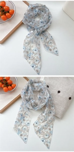Close-up of floral mesh scarf detailing vintage prints and premium brand labeling