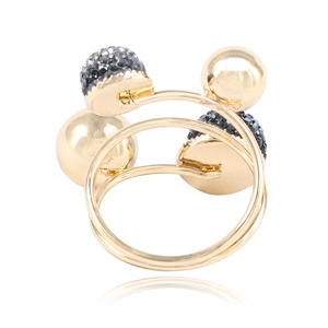 Detail of a multi-layer golden spiral brass ring featuring black crystal and metal beads