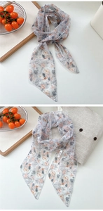 Detailed macro shot of French floral chiffon scarf featuring delicate edge stitching