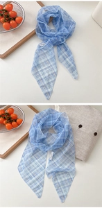 Detail of blue and white checkered mesh scarf showing sheer fabric texture and fine stitching