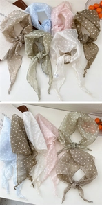Close-up of lightweight polka dot chiffon scarves in multiple pastel colors with fine edges