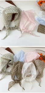 Detailed close-up showing soft chiffon texture and polka dot pattern on silk scarves