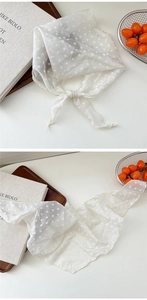 Close-up of lightweight white polka dot neck scarf with soft texture and fine edges