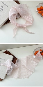 Macro shot of pink polka dot silk scarf with light translucent texture and edge detail