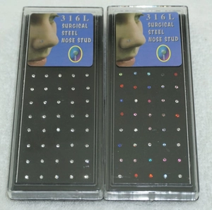 Detail of boxed 316L surgical steel nose studs in clear and mixed colors set