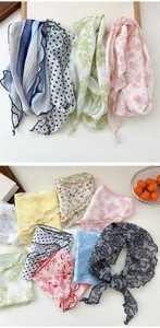 Detail of assorted floral and polka dot chiffon scarves with lace trim and soft patterns