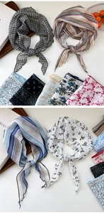 Detailed view of various floral and patterned neck scarves with soft fabric textures
