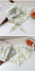 Detail of floral chiffon scarf showing thin semi-sheer fabric and delicate rolled edges