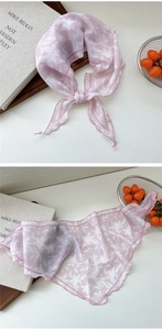 Detail view of pink floral chiffon neck scarf with fine rolled edges and stripe pattern