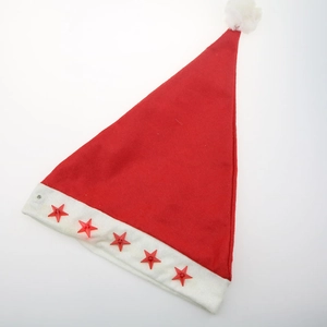 Detail of red Christmas hat with white fur trim and five glowing star decorations