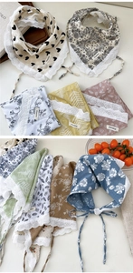 Detail of cotton linen triangle scarves featuring delicate lace edges and heart patterns