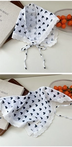 Detailed macro view of white heart print cotton scarf with delicate lace trimming