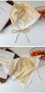 Detail of yellow cotton neckerchief showing geometric patterns and white lace edges