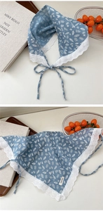 Close-up of floral blue cotton linen scarf with delicate white lace edges and ties