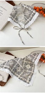 Close-up of paisley print cotton linen headscarf with white lace edges and ties