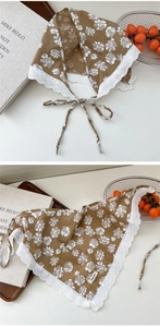 Detail of floral cotton linen headscarf with white lace trim and brand woven label