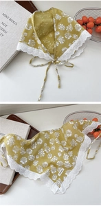 Close-up of mustard yellow linen triangle scarf with white lace trim and floral pattern