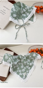 Detailed close-up of grass green floral cotton scarf with white lace trim and ties