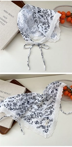 Close-up of white floral cotton headscarf with delicate crochet lace trimming