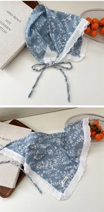 Detailed macro view of blue floral cotton scarf featuring delicate white lace trim edges