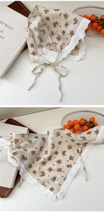 Detail of cottagecore floral cotton scarf featuring white lace edges and a vintage pattern