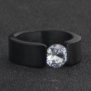 Top view of a black stainless steel ring with a tension-set round clear zircon stone