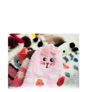 Close-up of pink rabbit plush socks with 3D ears and cartoon embroidery for kids