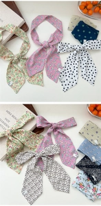 Macro shot of assorted floral and leopard print silk scarves with fine stitching detail