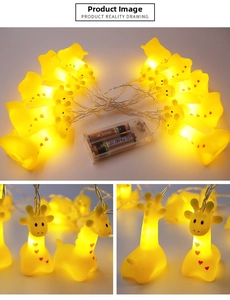 Macro detail of giraffe-shaped LED string lights with warm yellow glow and battery box