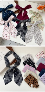 Detail of silk-like neckerchief showing paisley and floral patterns tied on accessories