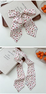 Detailed macro view of French style floral silk scarf with pointed ends and ribbon texture