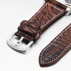 Oulm dual time zone watch featuring brown crocodile leather strap with white stitching