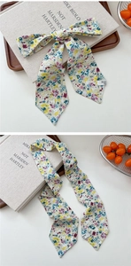 Close-up of floral print skinny silk scarf with pointed ends for hair and bag styling