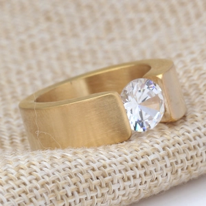 Close-up of 8mm brushed gold stainless steel ring featuring a large claw-set zircon stone