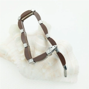 Men's fashion stainless steel and brown leather braided bracelet on white seashell background