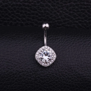 Polished silver navel ring with square zircon pendant on black leather background