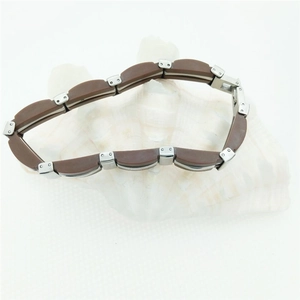Men's industrial brown and silver stainless steel link bracelet displayed on a white shell