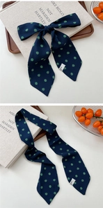 Detailed macro view of navy floral silk scarf tie with elegant pointed ends and patterns