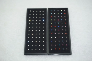 Macro detail of 60pcs stainless steel nose stud set with crystal rhinestones in boxes
