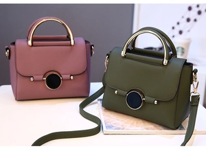 Detailed view of pink and dark green handbags with lychee texture and gold metal clasp