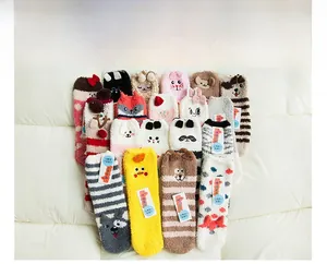 Flat lay of colorful coral fleece floor socks with various cute cartoon animal embroidery
