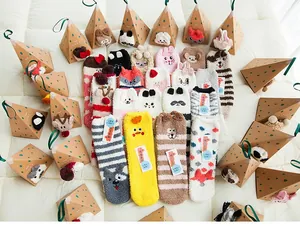 Detailed view of plush coral fleece kids socks with 3D cartoon animal embroidery and gift box